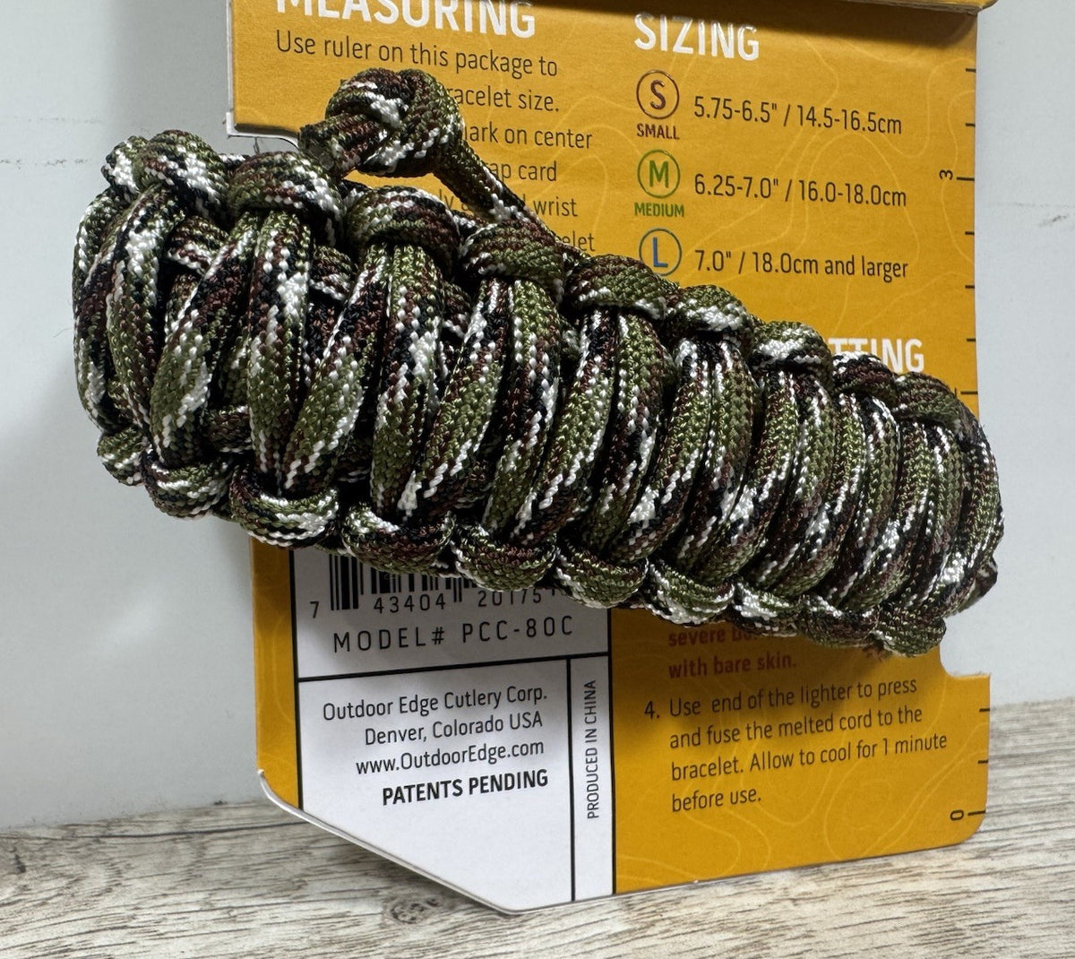 Outdoor Edge Paracord Survival Bracelet with Fixed Blade Knife - Camouflage, Medium